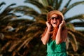 Young woman in the wind by the palm trees Royalty Free Stock Photo