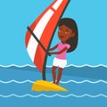 Young woman windsurfing in the sea.