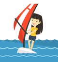 Young woman windsurfing in the sea.