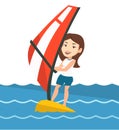 Young woman windsurfing in the sea.