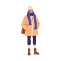 Young woman in winter clothes, casual outfit. Modern girl wearing hat, scarf, warm jacket, bag, socks in boots. Female Royalty Free Stock Photo