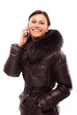 Young woman in a winter jacket speaks on phone