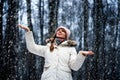 Young woman in a winter park in snowfall Royalty Free Stock Photo