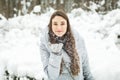 Young woman winter portrait. Winter woman Blowing Snow in forest
