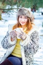 Young woman winter portrait. Shallow dof. Smiling woman holding a cup of tea. Royalty Free Stock Photo