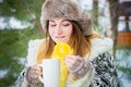 Young woman winter portrait. Shallow dof. Smiling woman holding a cup of tea. Royalty Free Stock Photo