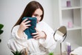 Young woman wiping her face with towel in bathroom. Royalty Free Stock Photo