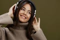 young woman wireless headphones music fun technology Green background Royalty Free Stock Photo