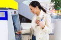 Woman withdrawing cash at an ATM Royalty Free Stock Photo