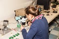 Young female electronic technician at work.