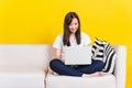 Young woman work from home she sitting on sofa using laptop computer in house Royalty Free Stock Photo