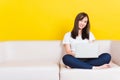 Young woman work from home she sitting on sofa using laptop computer in house Royalty Free Stock Photo