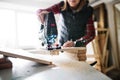 Young woman worker in the carpenter workroom. Royalty Free Stock Photo