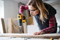 Young woman worker in the carpenter workroom. Royalty Free Stock Photo
