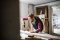 Young woman worker in the carpenter workroom. Royalty Free Stock Photo