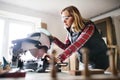 Young woman worker in the carpenter workroom. Royalty Free Stock Photo