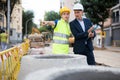 Young woman worker on a construction site shows something to a man engineer Royalty Free Stock Photo