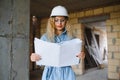 Young woman worker with a white helmet on the construction site. Royalty Free Stock Photo