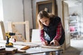 Young woman worker in the carpenter workroom.