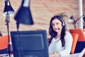 Young woman working in call centre, surrounded by colleagues Royalty Free Stock Photo