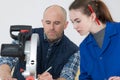 Young woman working at carpenter shop with teacher Royalty Free Stock Photo