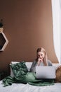 Young woman working on computer in bed. Relaxing at home. Royalty Free Stock Photo
