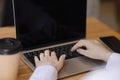 Young woman working on a computer at a desk in an office, close-up. Royalty Free Stock Photo