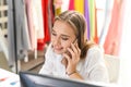 Young woman working on the desk with computer pc and use smartphone or Talking phone to Someone on her mobile phone about business Royalty Free Stock Photo