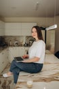 Young woman working from home office. Freelancer using laptop and the Internet for shopping online. Happy girl smiling Royalty Free Stock Photo