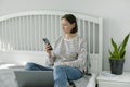 Young woman working from home office. Freelancer using laptop, phone and the Internet Royalty Free Stock Photo