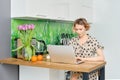 Woman working at home office, she is sitting in the kitchen with her laptop Royalty Free Stock Photo