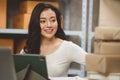 Young woman working at home for packeting parcel boxes to shipping delivery services to customer Royalty Free Stock Photo