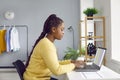 Young woman working from home, sitting at her desk and using her laptop computer Royalty Free Stock Photo