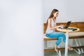 Young woman working with laptop in a cafe.