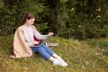Young woman working on laptop in forest, space for text Royalty Free Stock Photo