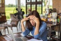 Young woman working on laptop having a headache. Royalty Free Stock Photo