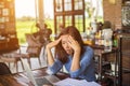 Young woman working on laptop having a headache. Royalty Free Stock Photo