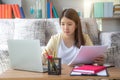 Young woman working on laptop at home, female using laptop computer sitting in living room Royalty Free Stock Photo