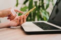 Young woman working on laptop at home, using mobile phone. work from home, stay safe during coronavirus covid-2019 concept Royalty Free Stock Photo