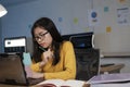 Young woman working on laptop in the office. Royalty Free Stock Photo