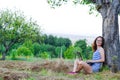 Young woman working on laptop outdoors, free space. Royalty Free Stock Photo