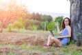 Young woman working on laptop outdoors, free space. Royalty Free Stock Photo