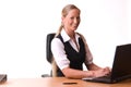 Young woman working at a laptop and smiling Royalty Free Stock Photo