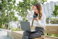 young woman working laptop and using mobile smartphone outdoor building exterior Royalty Free Stock Photo