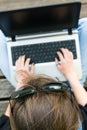 Young woman working on a laptop. View from above.