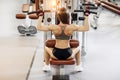 Young woman working at the lat pulldown machine in the gym,