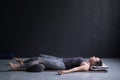 Woman working out, doing yoga exercise on wooden floor, lying in Shavasana Royalty Free Stock Photo