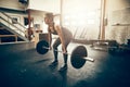 Young woman working out with heavy weights in a gym Royalty Free Stock Photo