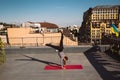 Young woman working out outdoors and doing yoga handstand exercise Royalty Free Stock Photo