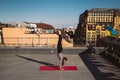 Young woman working out outdoors and doing yoga handstand exercise Royalty Free Stock Photo